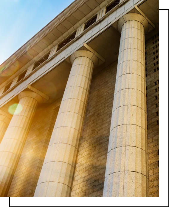 Courthouse columns with sunlight symbolizing strength and legal integrity