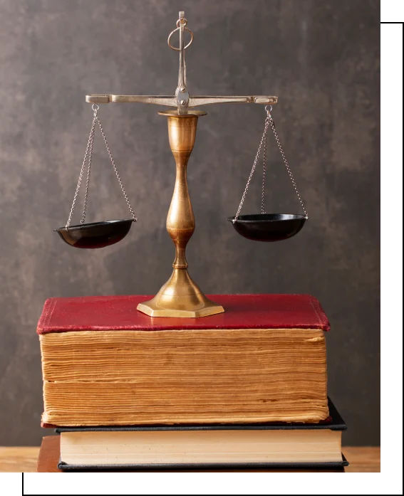 Scales of justice resting on legal books symbolizing legal expertise and fairness